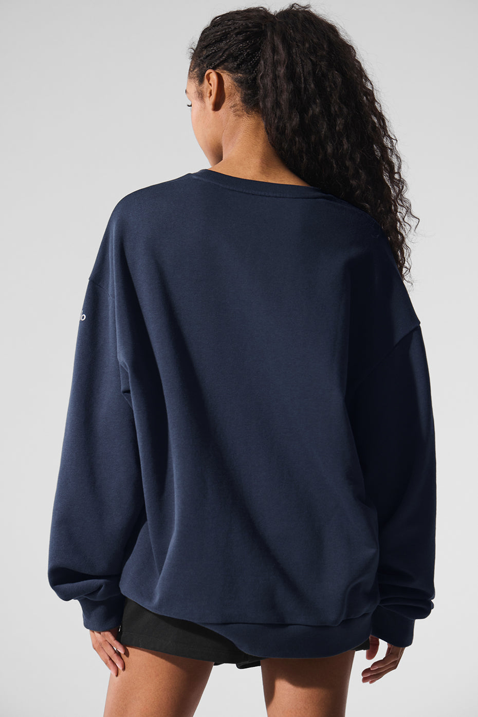 Model wearing the crewneck sweatshirt in an urban setting.