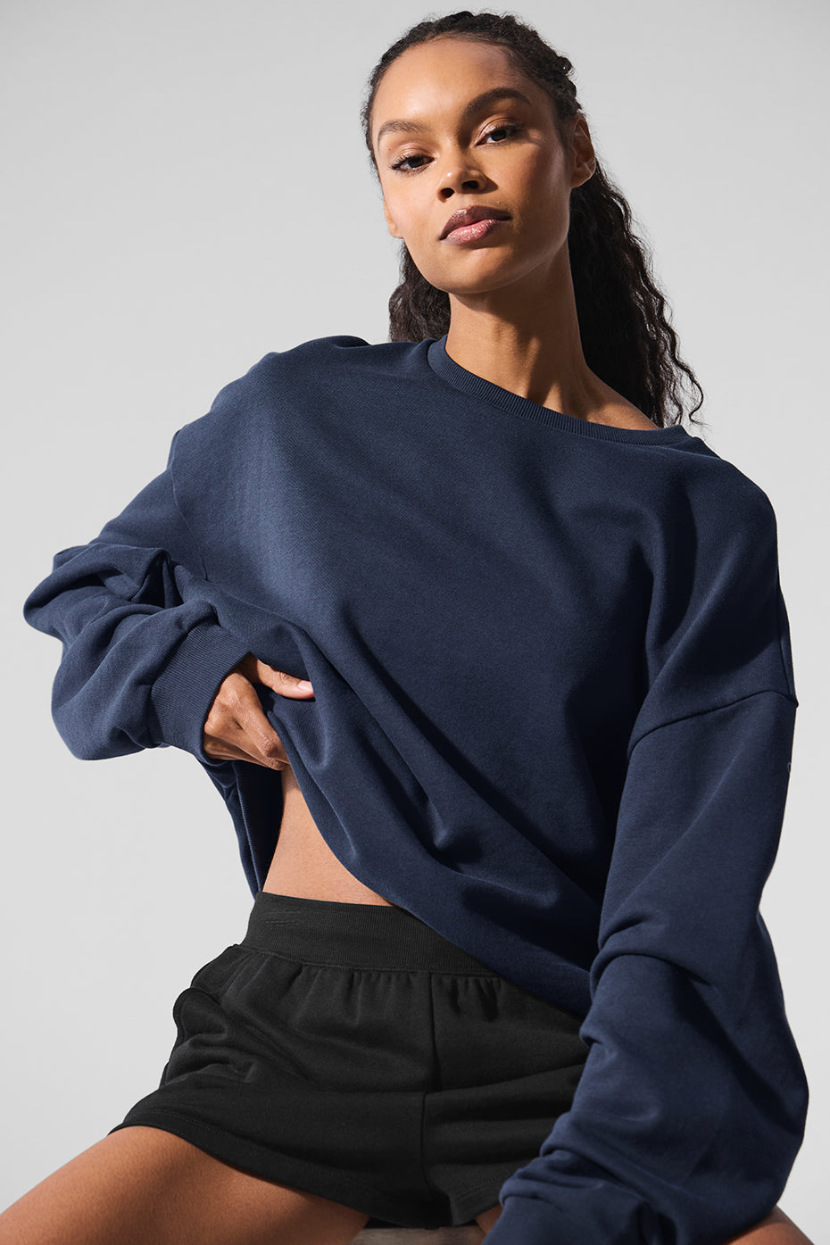 Close-up of the navy blue sweatshirt fabric texture.