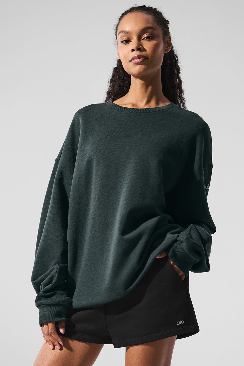 Front view of the charcoal green crew neck pullover highlighting cuffed hem and neckline