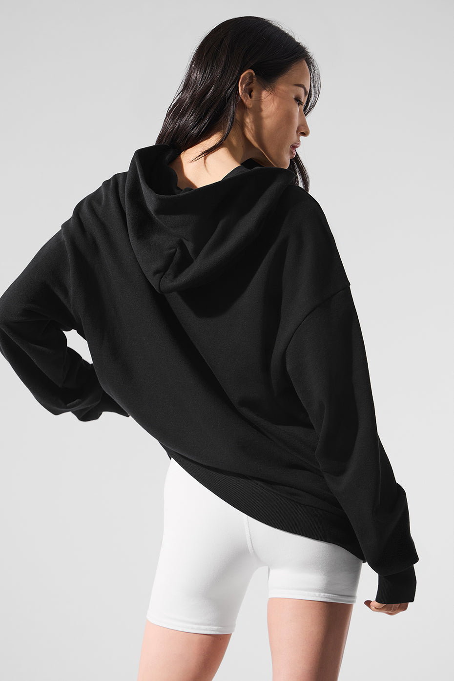 Close-up of black zip up hoodie fabric and zipper detailing