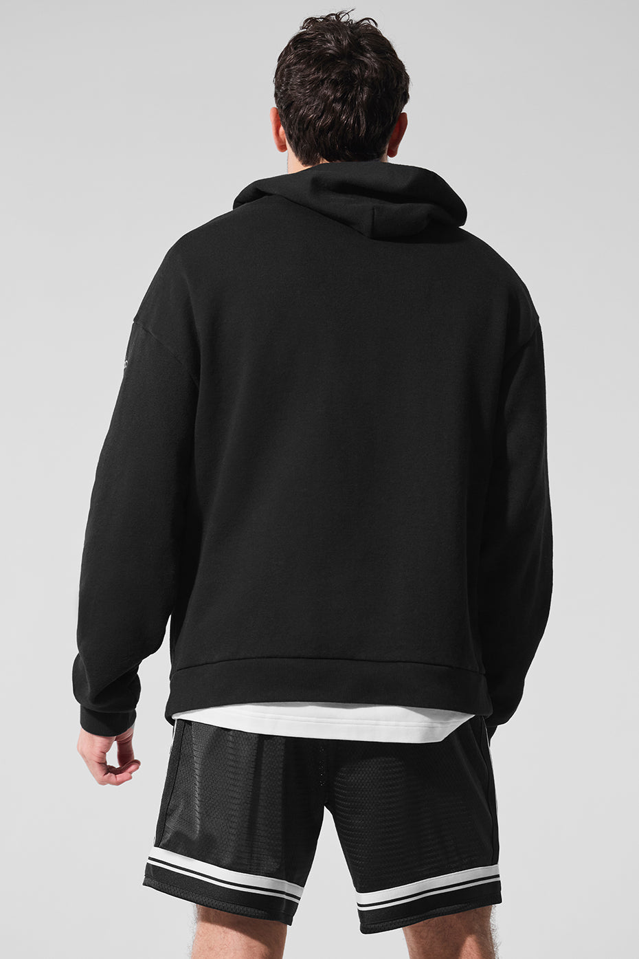 Close-up of the fabric texture of the black zip up hoodie.