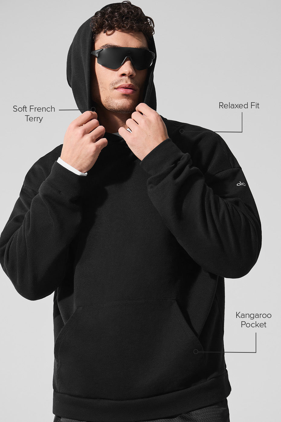 Model wearing the black essentials hoodie during a casual outing.
