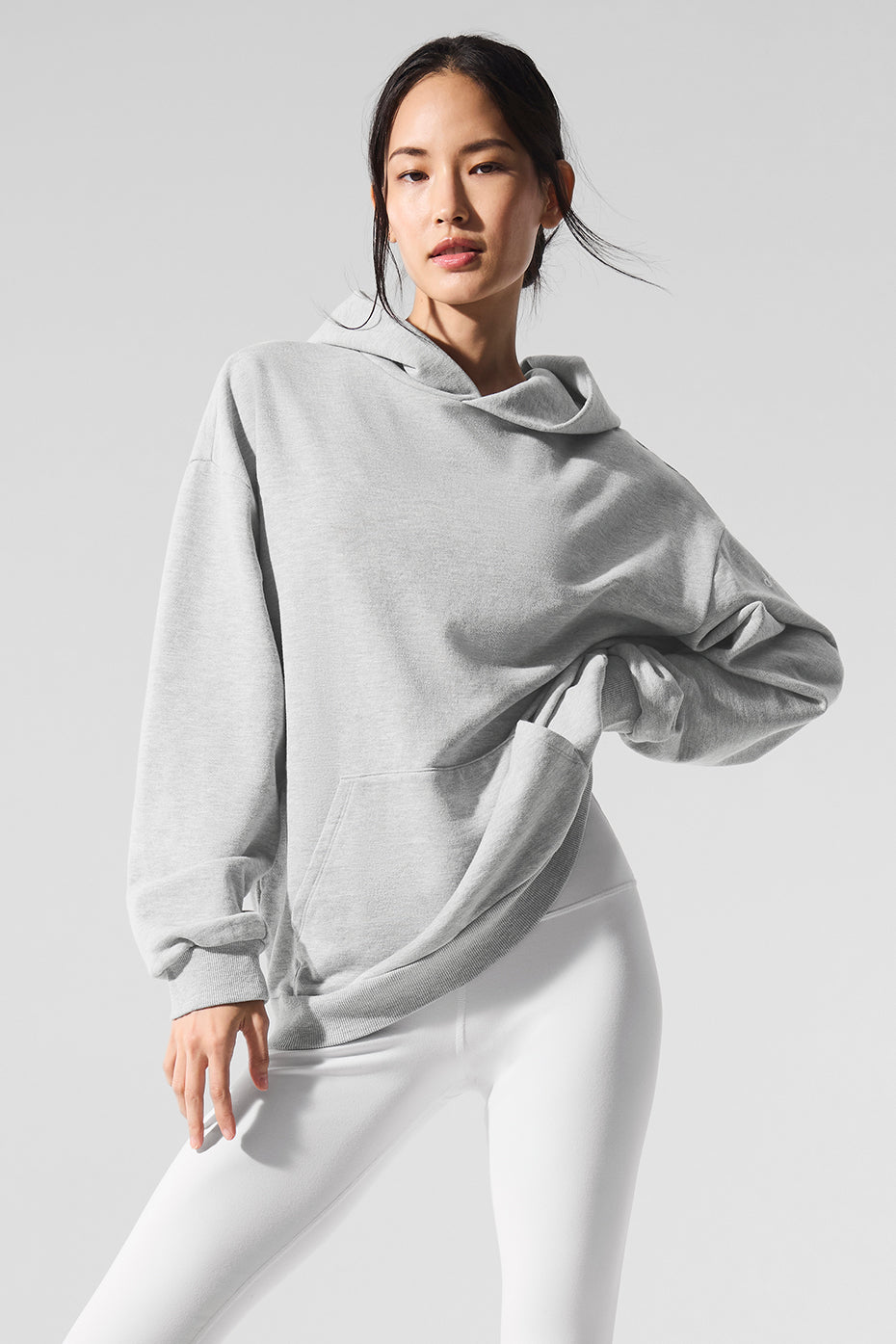 Front view of cozy comfort hoodie in athletic heather grey on a model during a workout