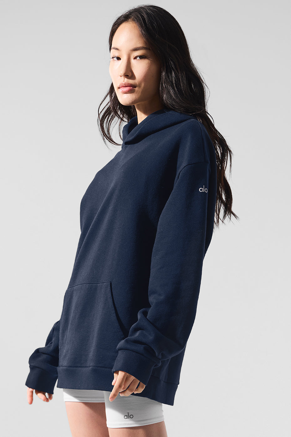 Flat-lay of parke sweatshirt beside athletic shoes and gym gear