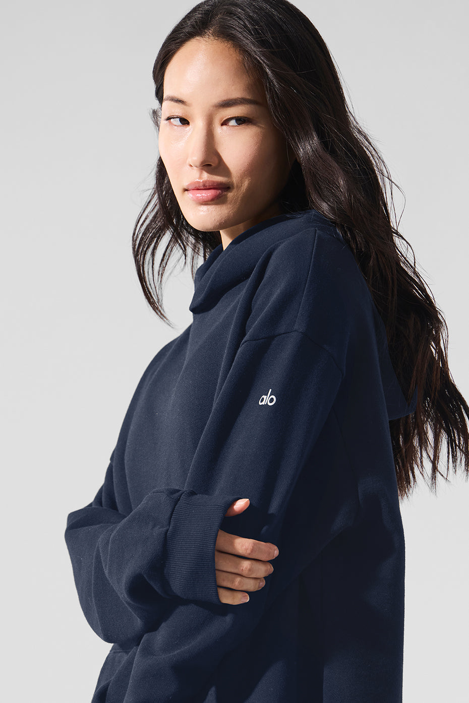 Close-up of navy hoodie sleeve showing ribbed cuffs and smooth texture