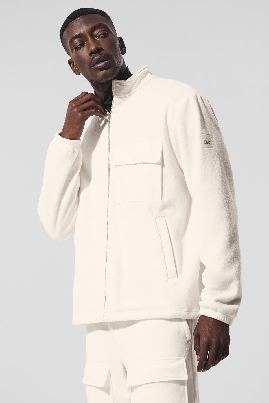 Front view of the ArcticEdge fleece jacket with zippered pockets and tall collar in an outdoor setting