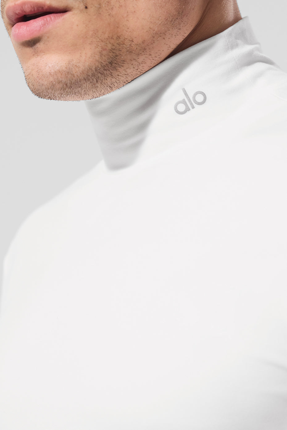 White mock neck t shirt with reflective logo suitable for athletic wear