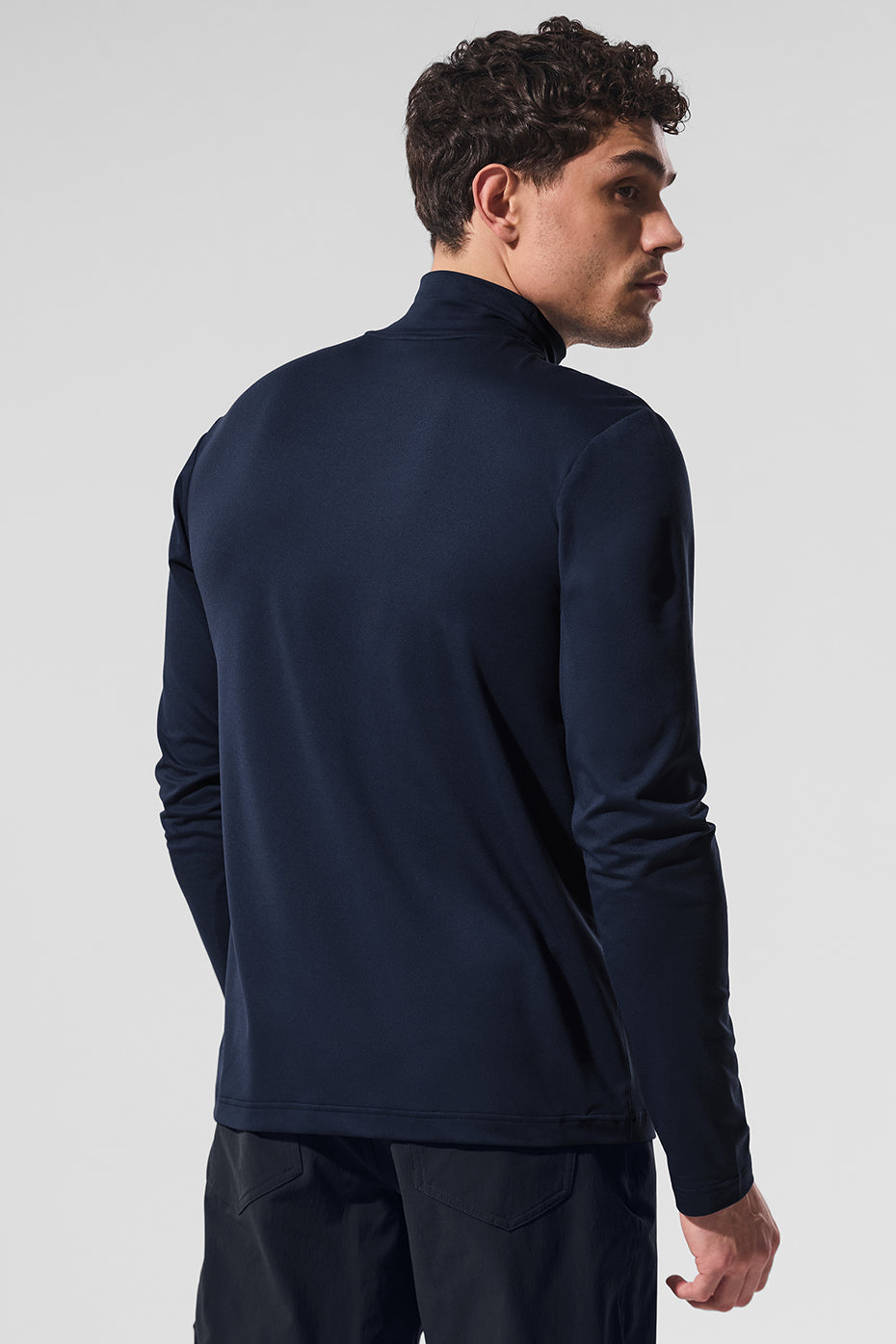 Back view of womens activewear long sleeve tops in navy, showcasing fit and stretch fabric.