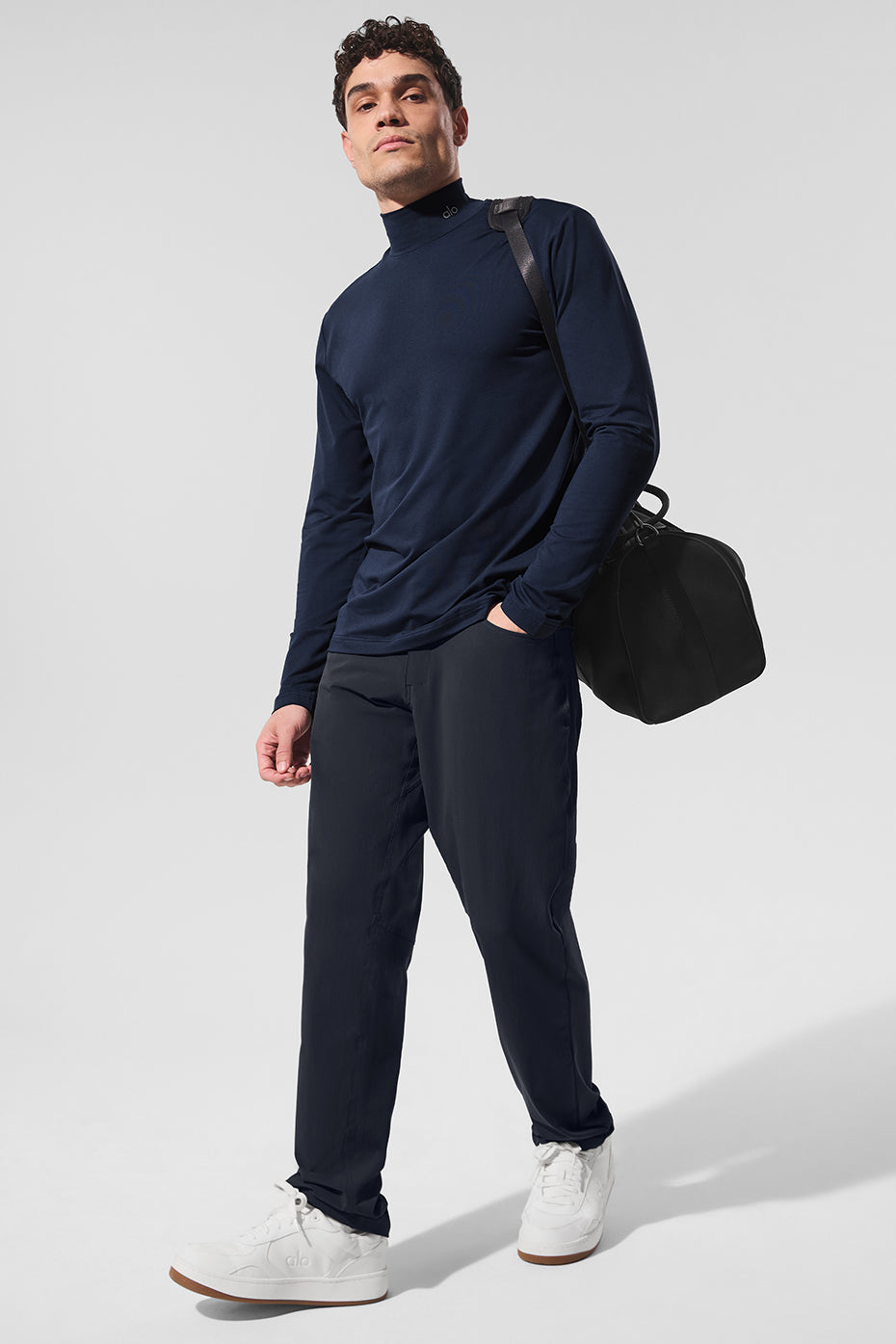 Close-up of mock neck shirt collar with reflective detail, worn at outdoor track.