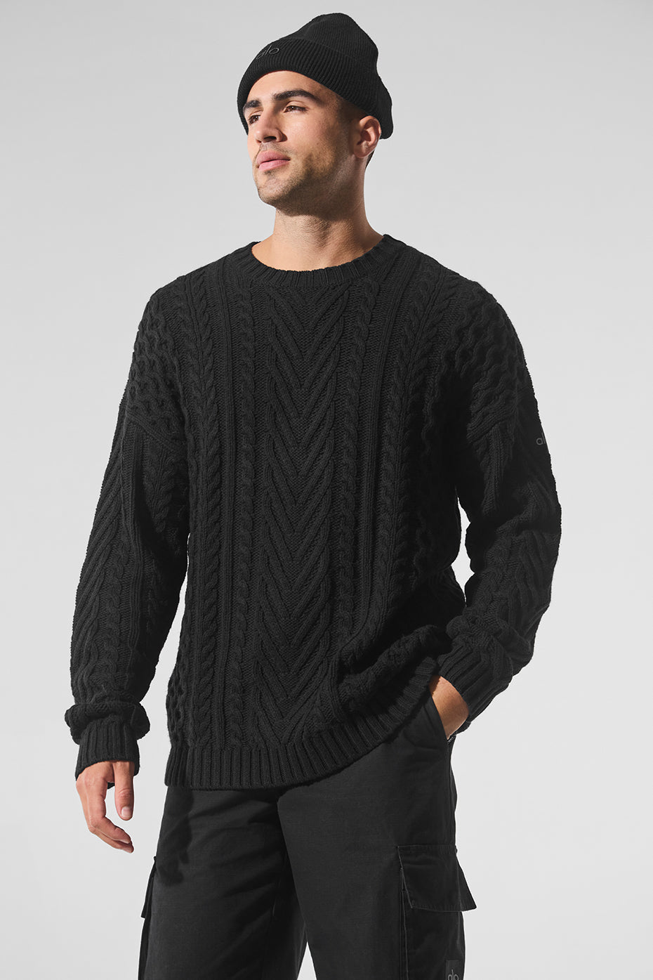 Front view of black cable knit sweater with crew neck for casual wear