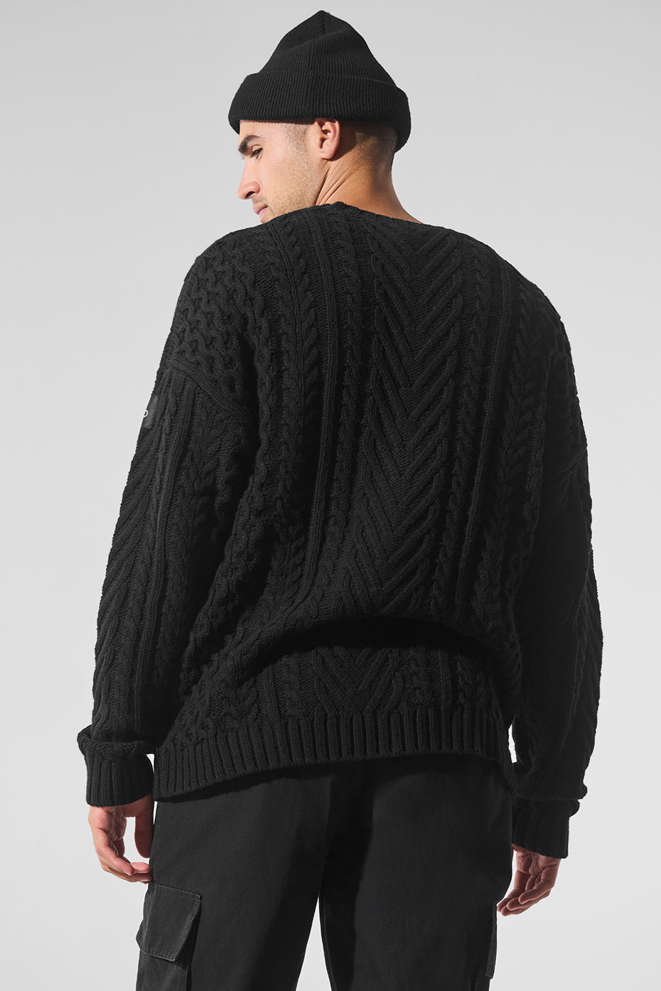 Close-up of knit pattern on black turtleneck sweater showing texture