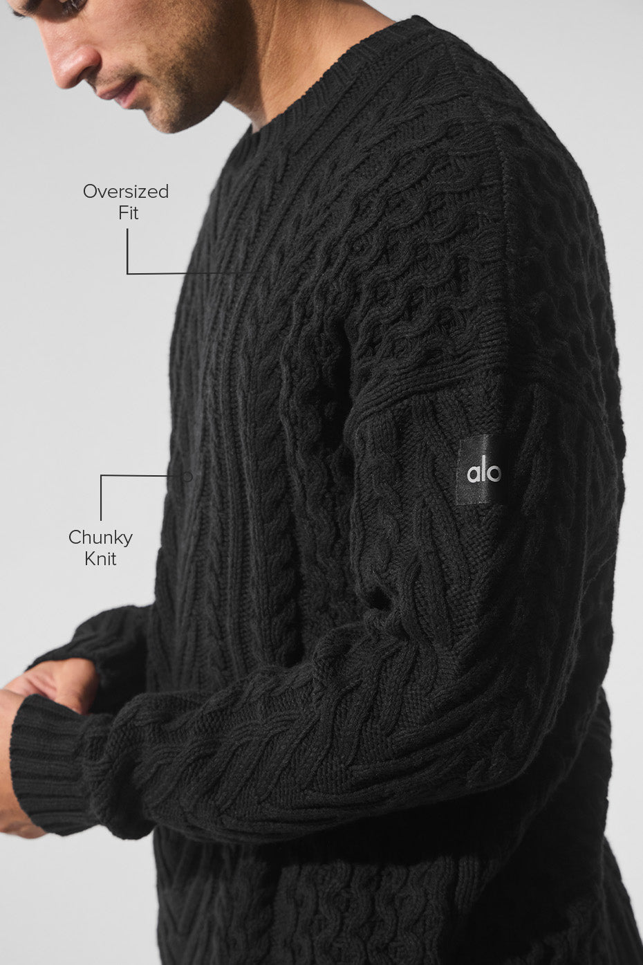Model wearing black sweater dress with cable knit details for fall fashion