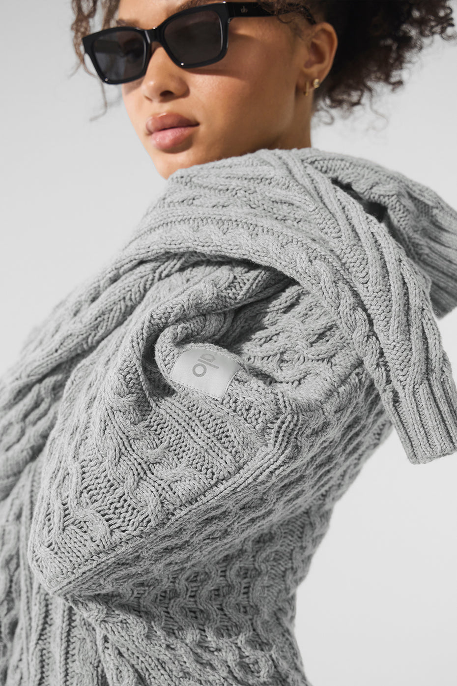 Model wearing the classic cable knit sweater styled for a night out