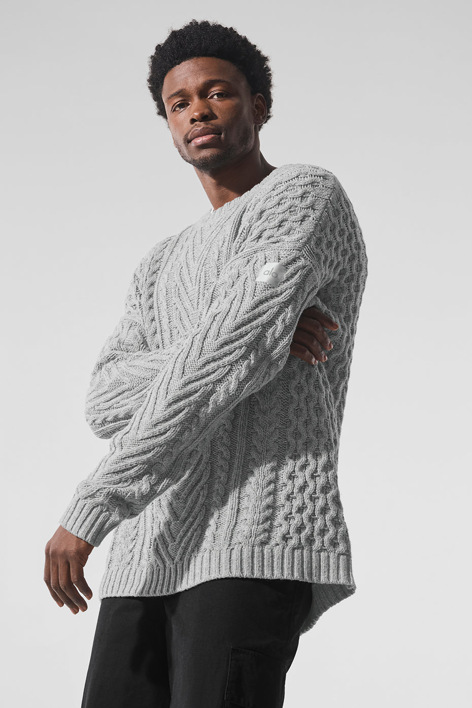 Close-up of cable knit detailing on heather grey crewneck
