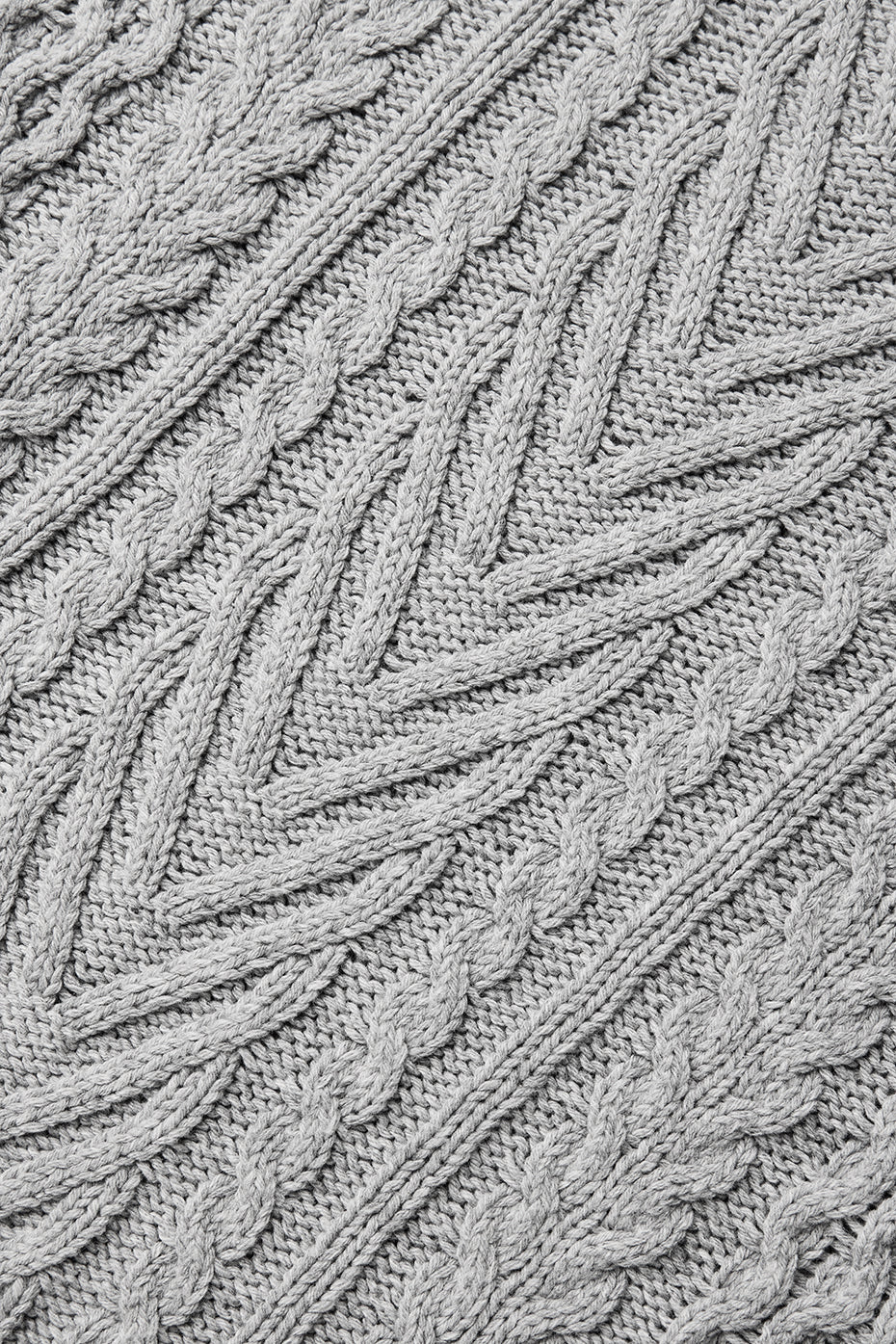Close-up of the detailed cable knit pattern on the sweater
