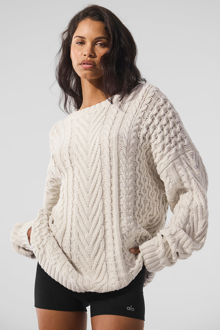 Front view of a chunky knit sweater in bone color, perfect for layering.