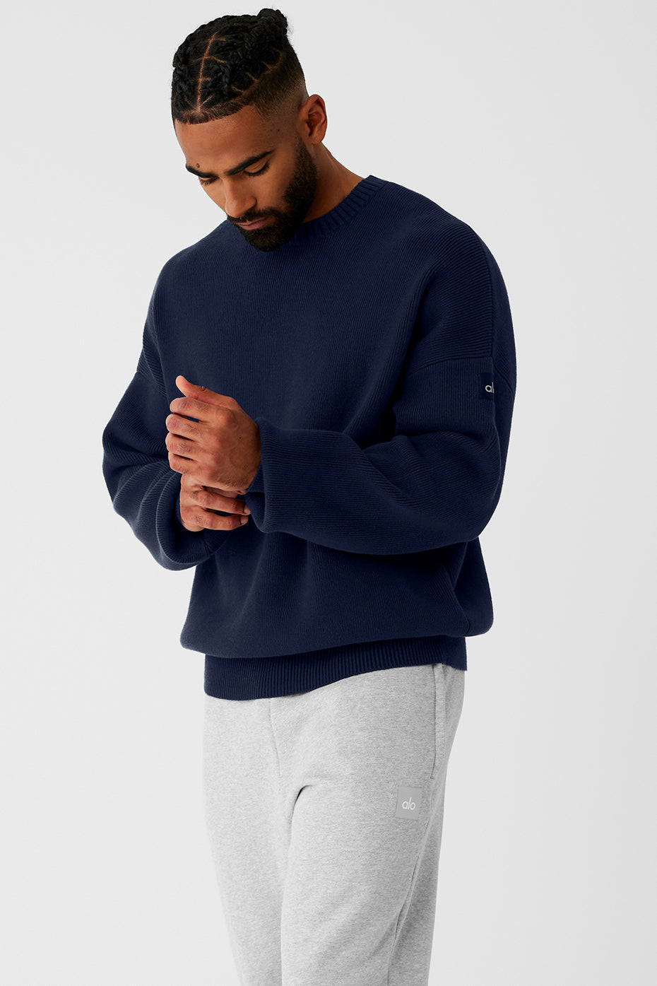 Detail of the cuffs on the mens cable knit sweater, highlighting its cozy texture.