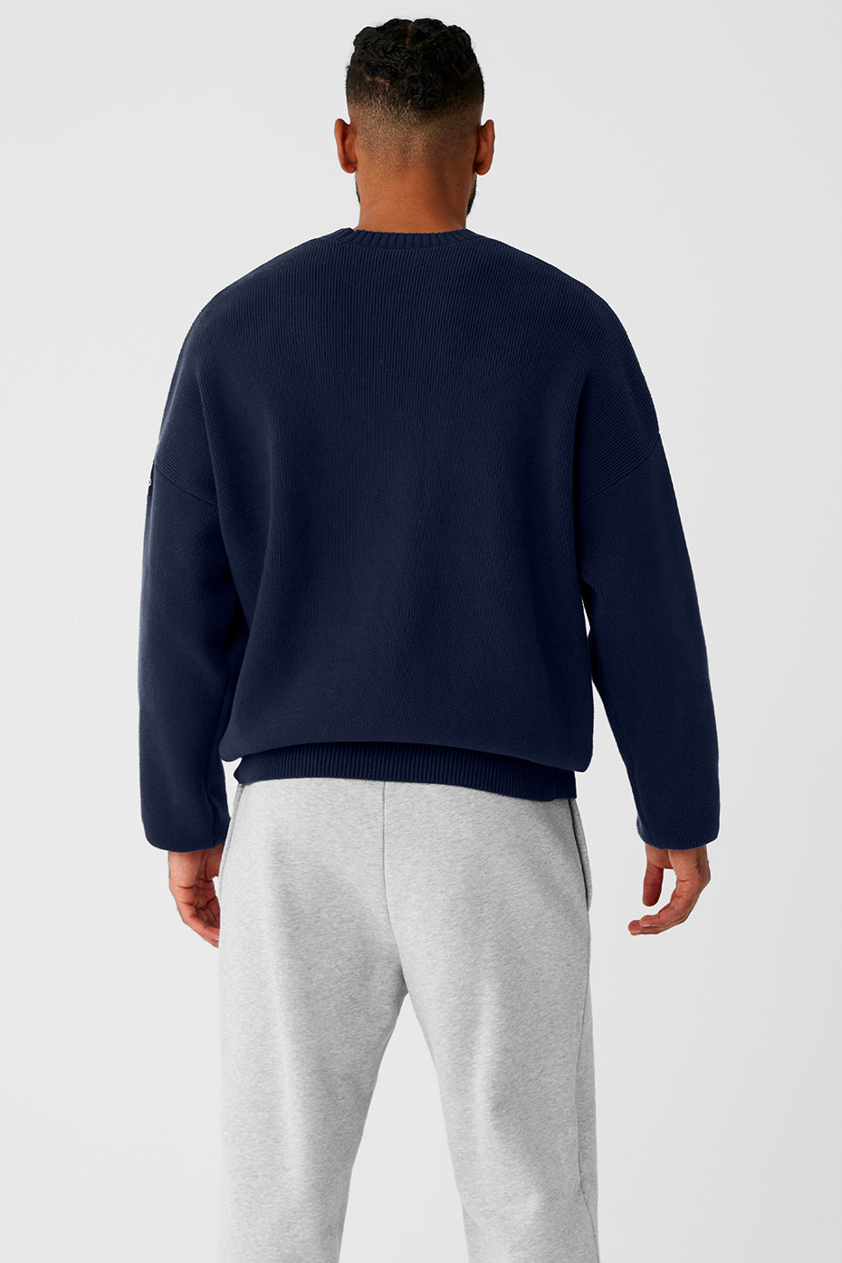 Model showcasing the oversized fit of the navy sweater in a casual setting.