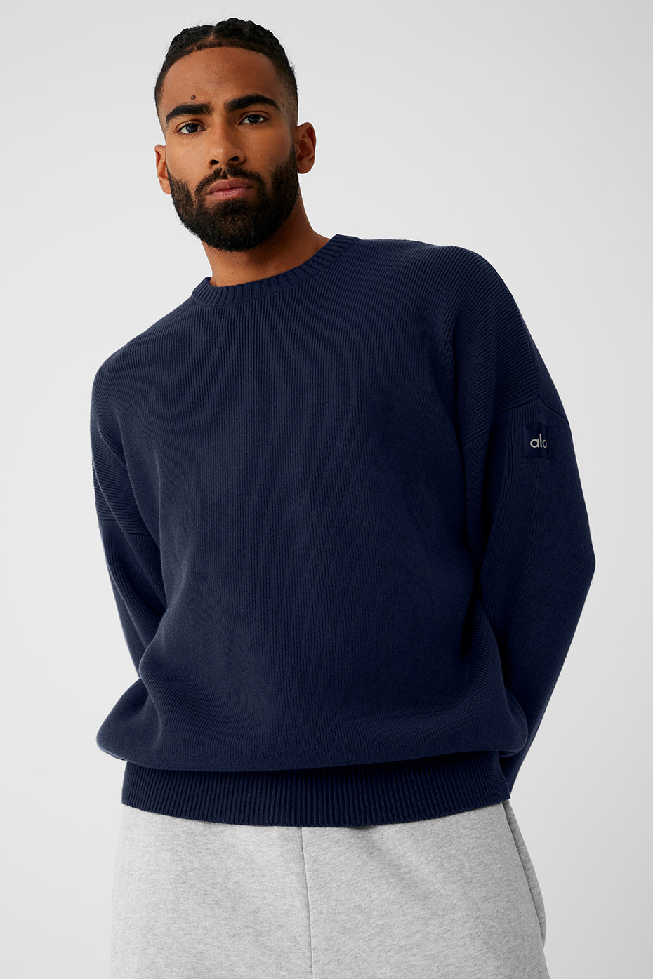 Model showcasing the oversized fit of the navy sweater in a casual setting.