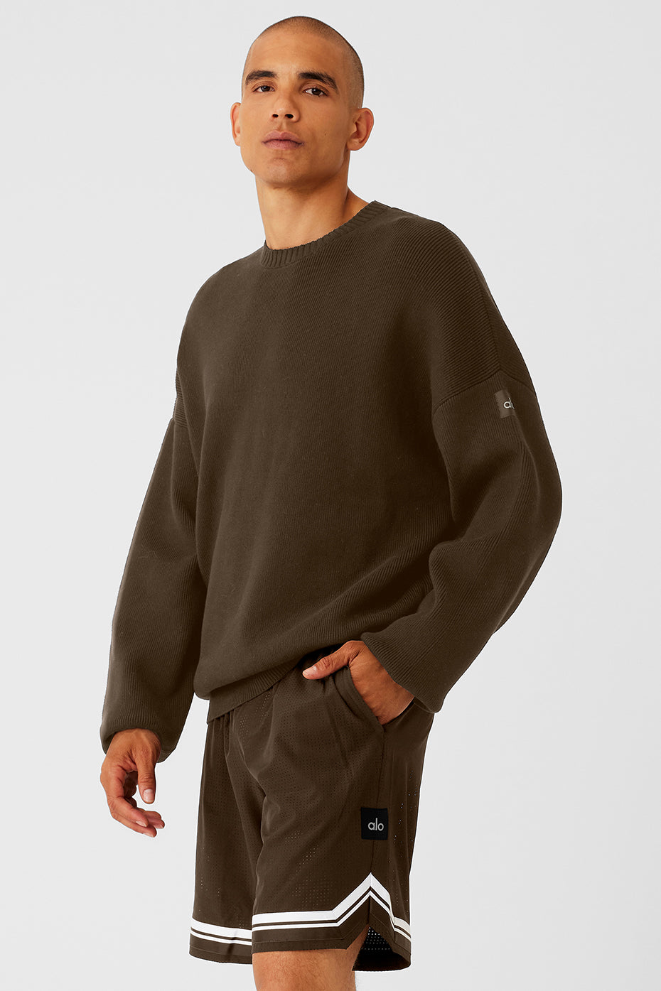 Model wearing a mens cable knit sweater outdoors on a chilly day