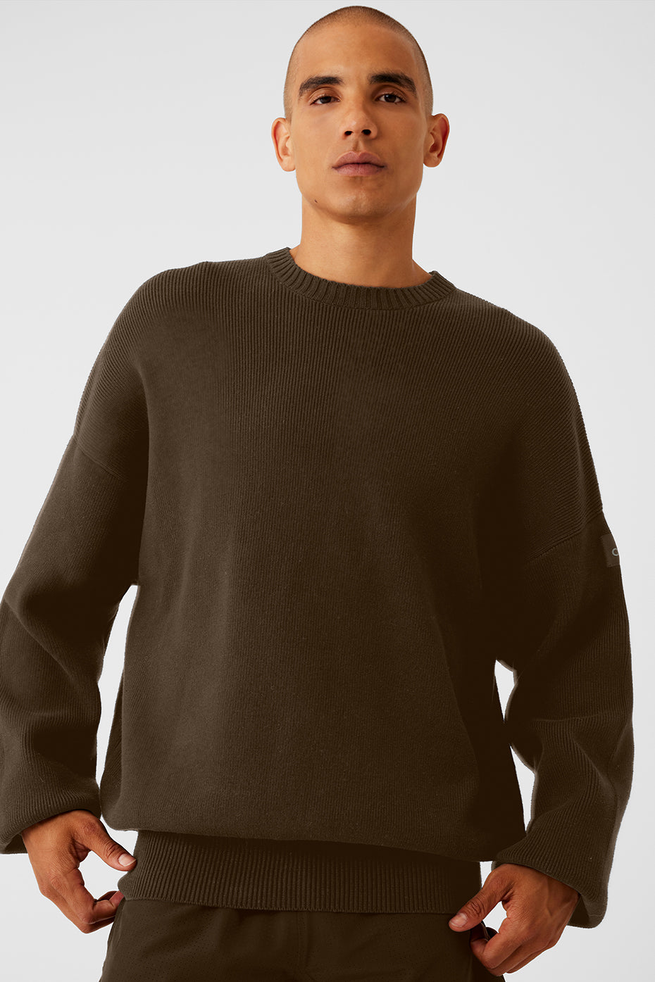 Front view of mens crew neck sweater in espresso color, styled with jeans