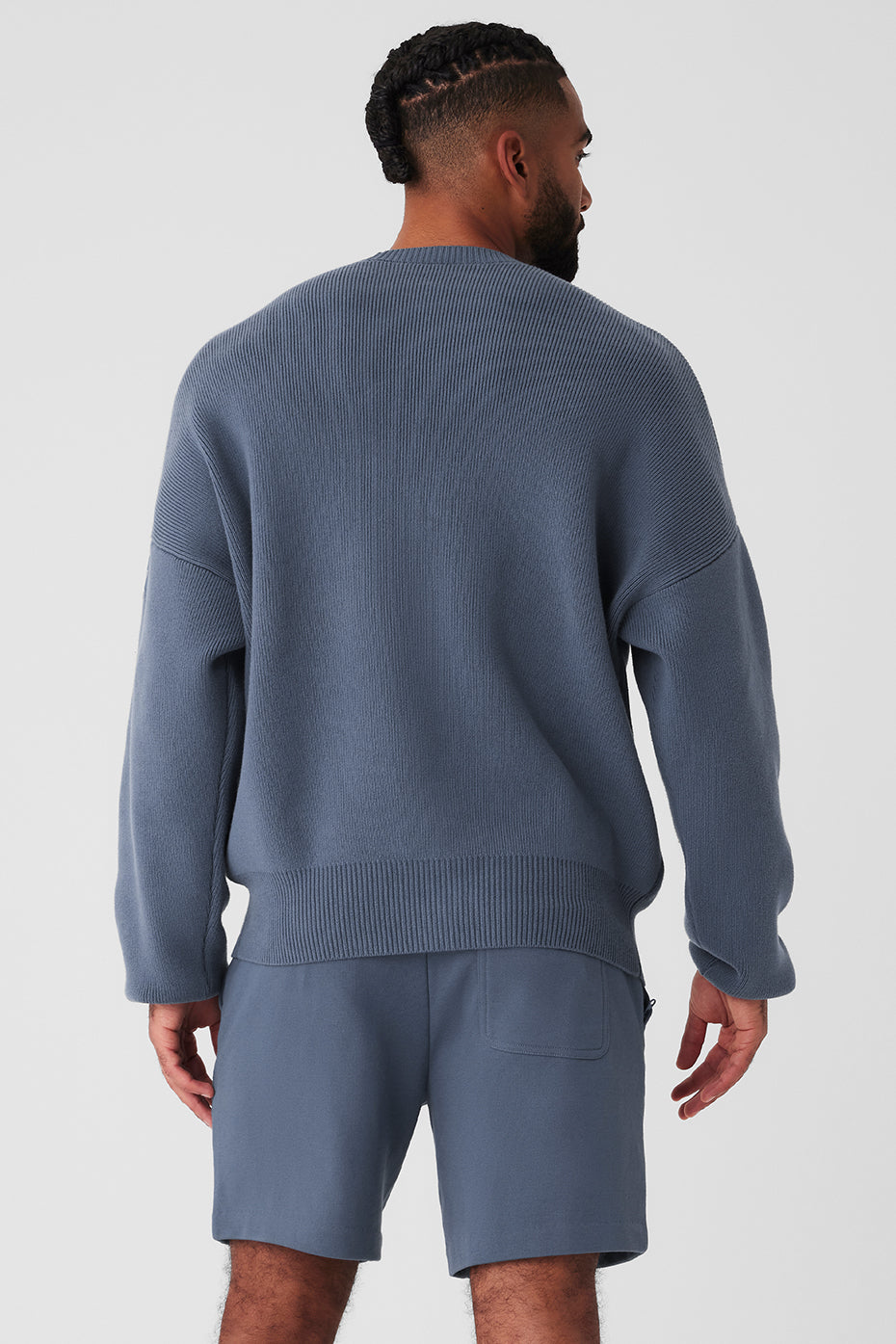 Close-up of the ribbed detailing on the cuffs and neckline of the sweater.