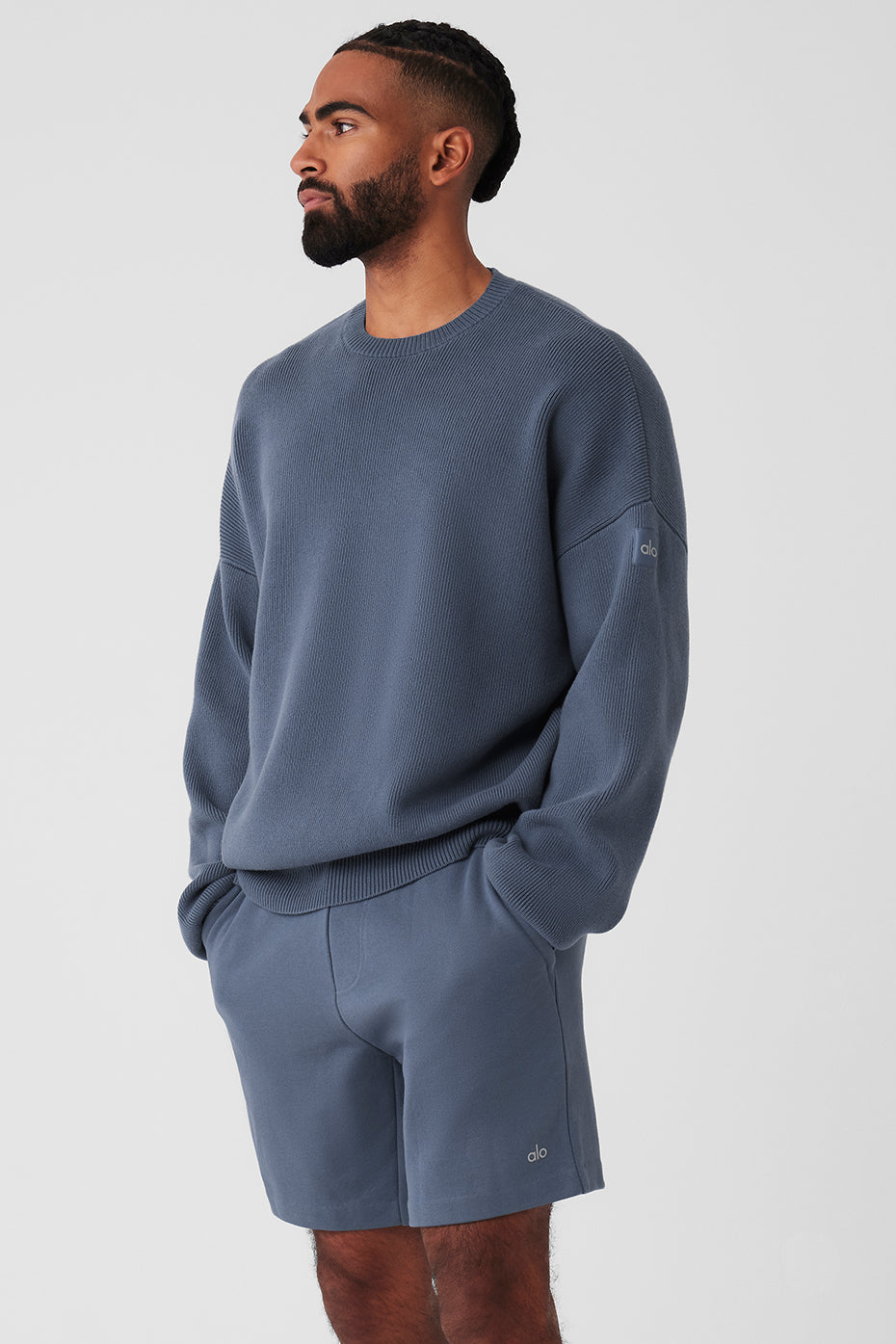 Model wearing the oversized crew neck sweater styled with trousers.