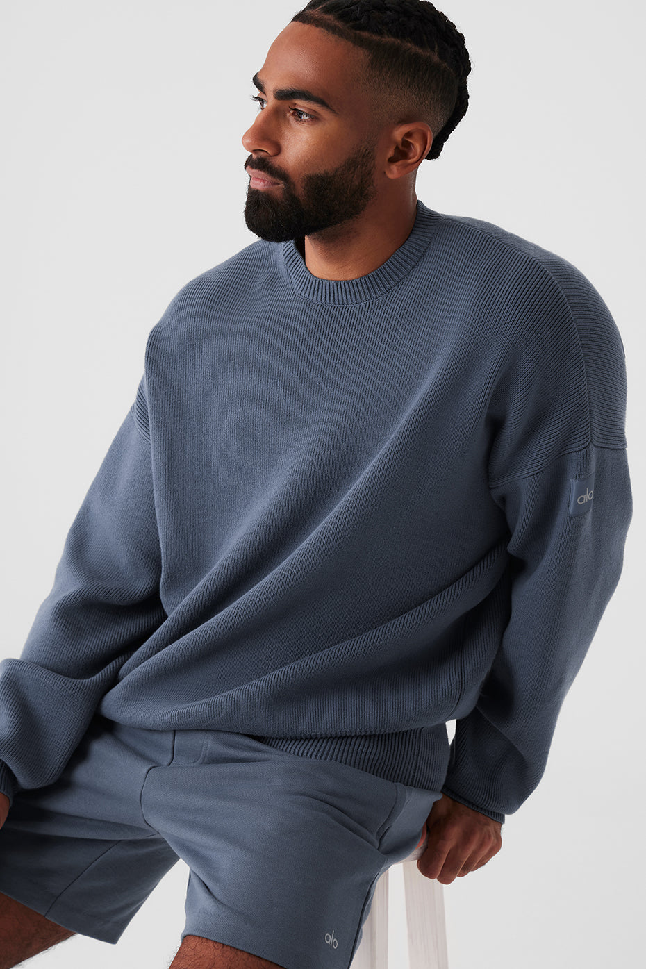 Close-up of the ribbed detailing on the cuffs and neckline of the sweater.