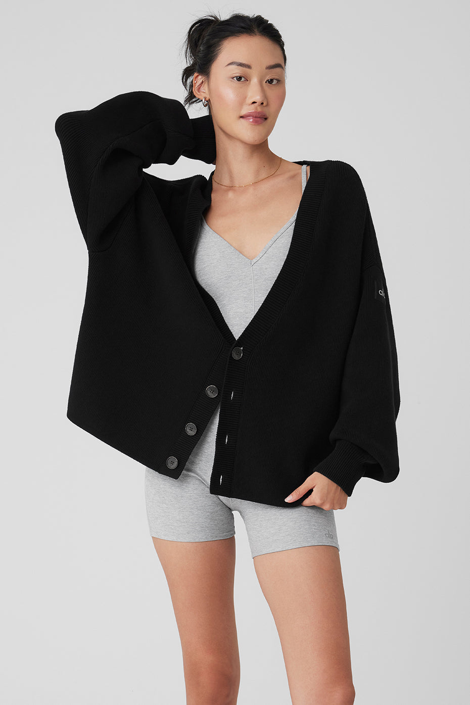 Front view of the black oversized cardigan, showcasing its cozy design.