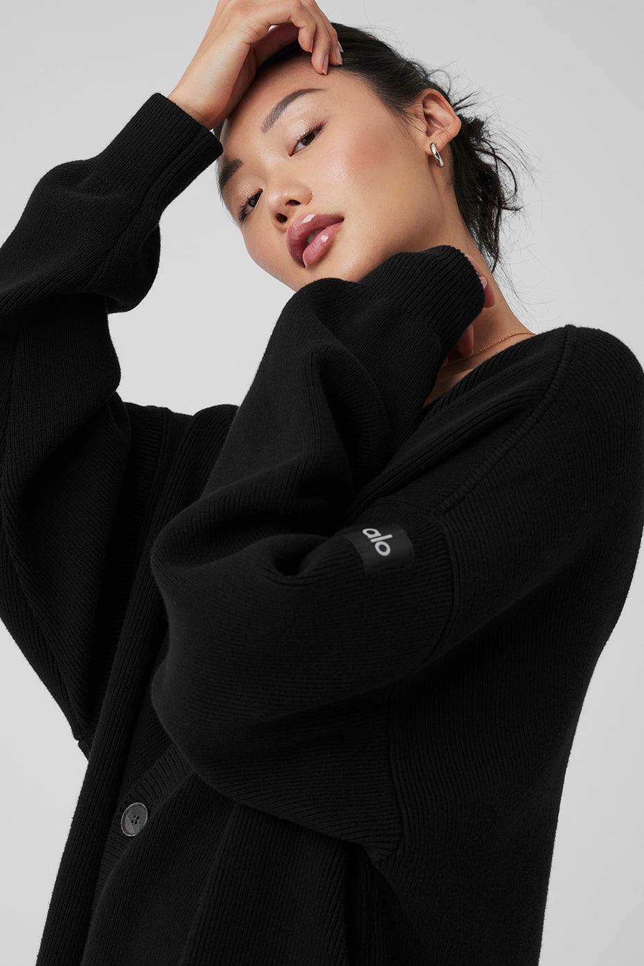 Front view of the black oversized cardigan, showcasing its cozy design.