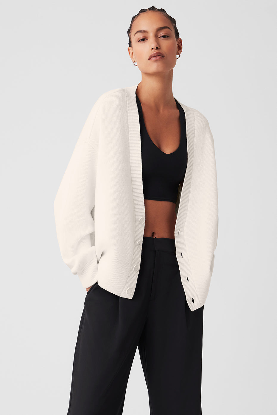 Model wearing the Ivory Scholar Cardigan Sweater layered over a tee