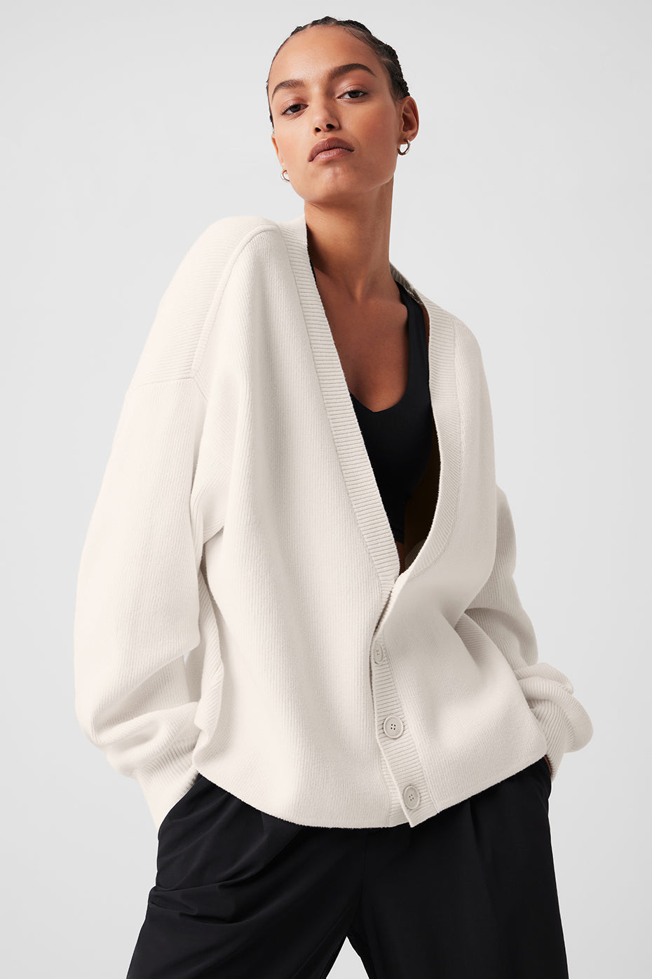Model wearing the Ivory Scholar Cardigan Sweater layered over a tee