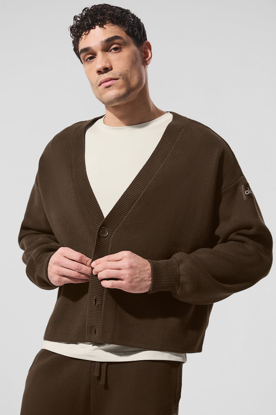 Front view of espresso cardigan sweater styled over a white tee