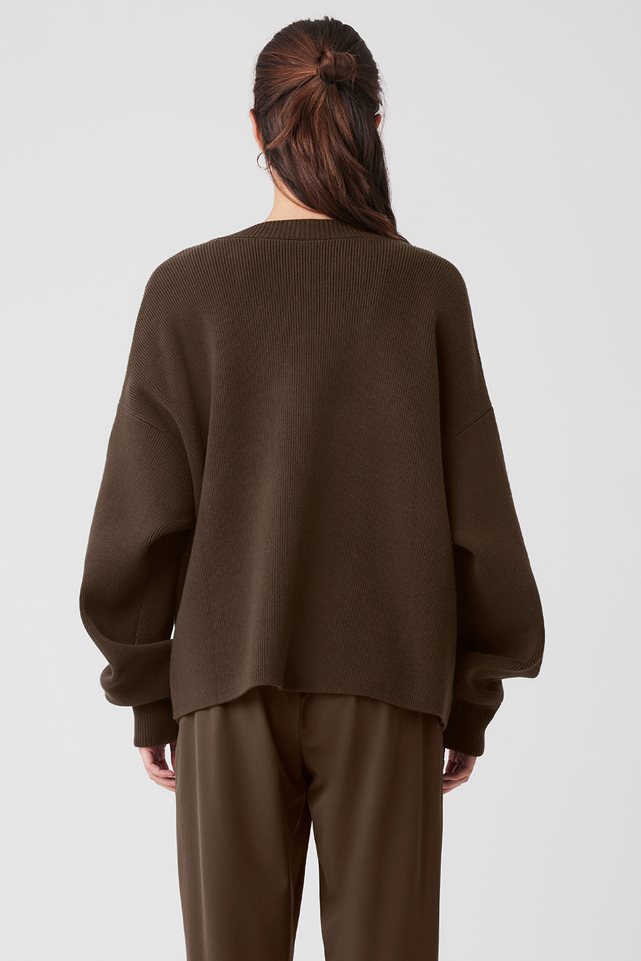 Fashionable cashmere cardigan paired with trousers and heeled boots.