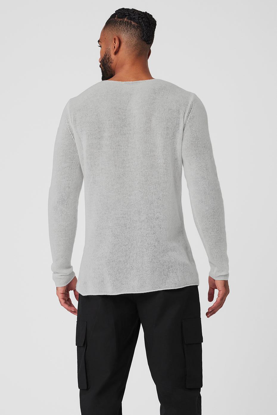 Side angle showcasing the elongated hem and relaxed neckline of the long sleeve cashmere top