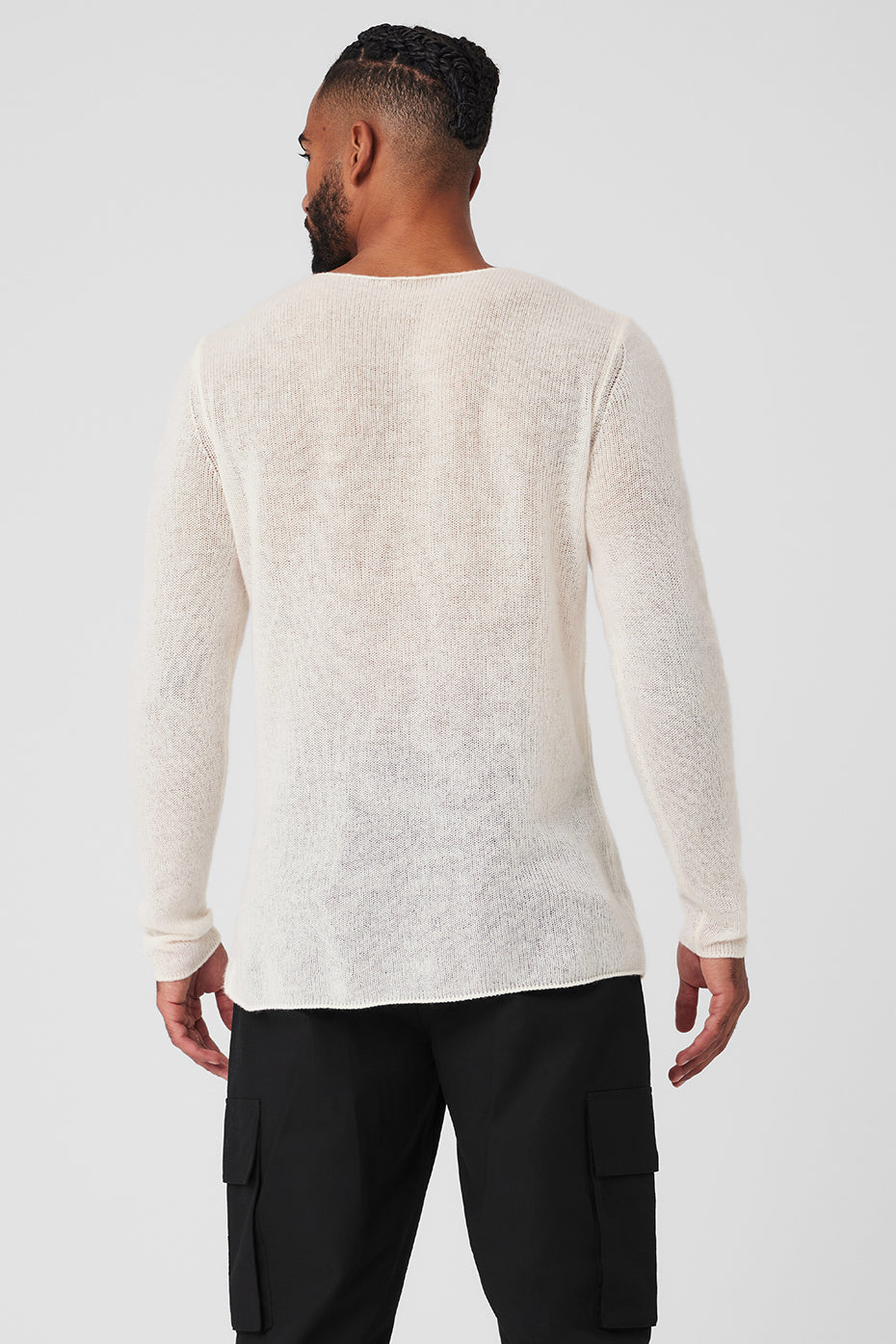 Side angle showing relaxed fit and wide neckline of luxury knitwear for men.