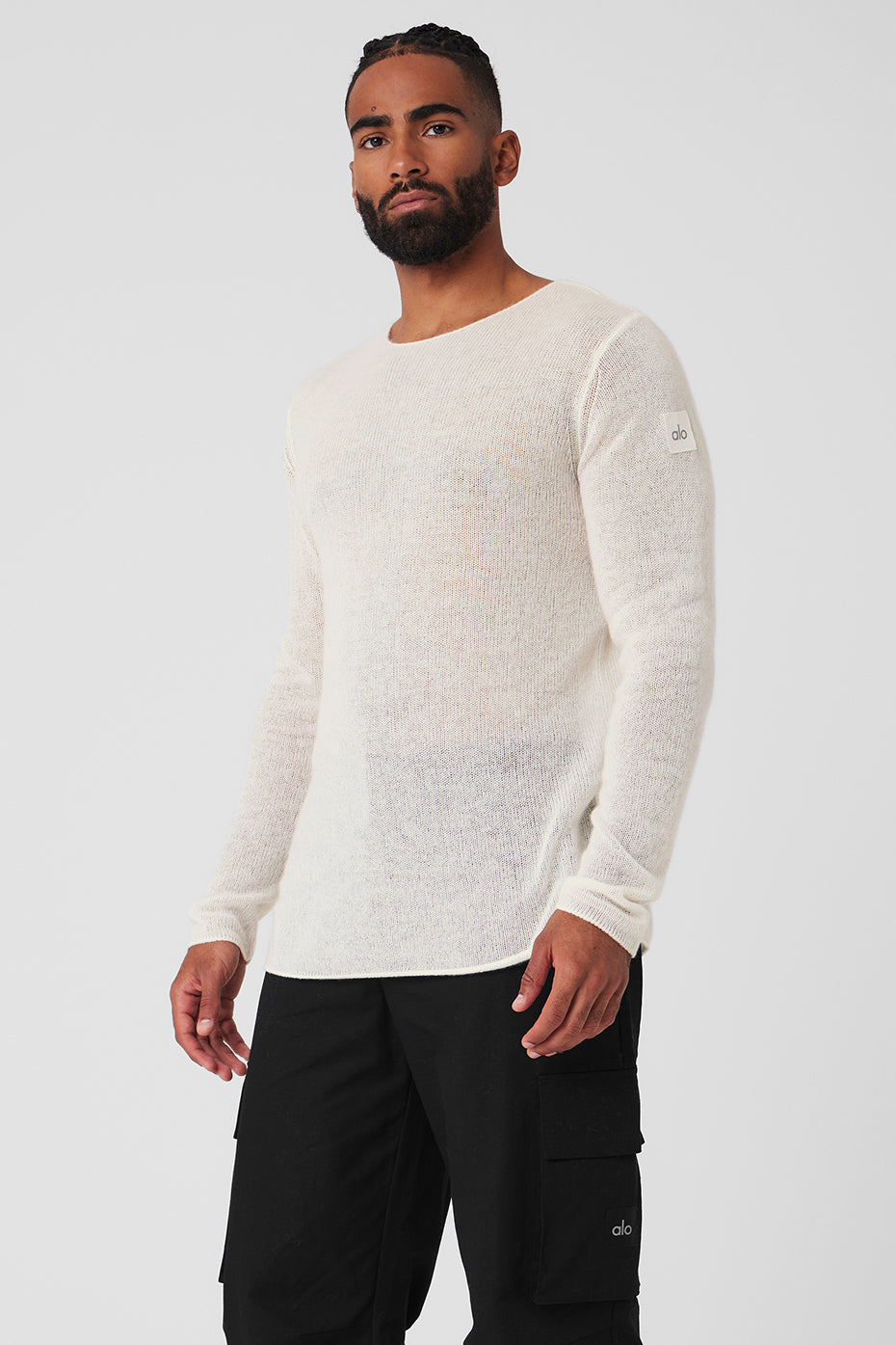 Styled ivory long sleeve top layered under jacket for casual cold-weather look.