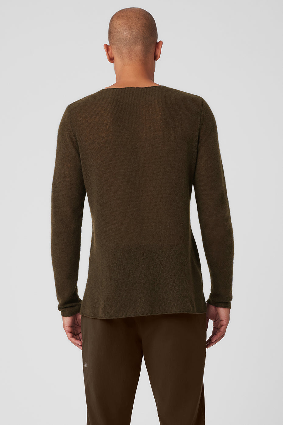 Man layering the cashmere cardigan sweater over a white tee for a casual look.