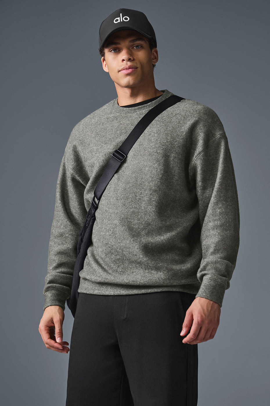Side view showing the slouchy, comfortable drape of the oversize sweatshirt.