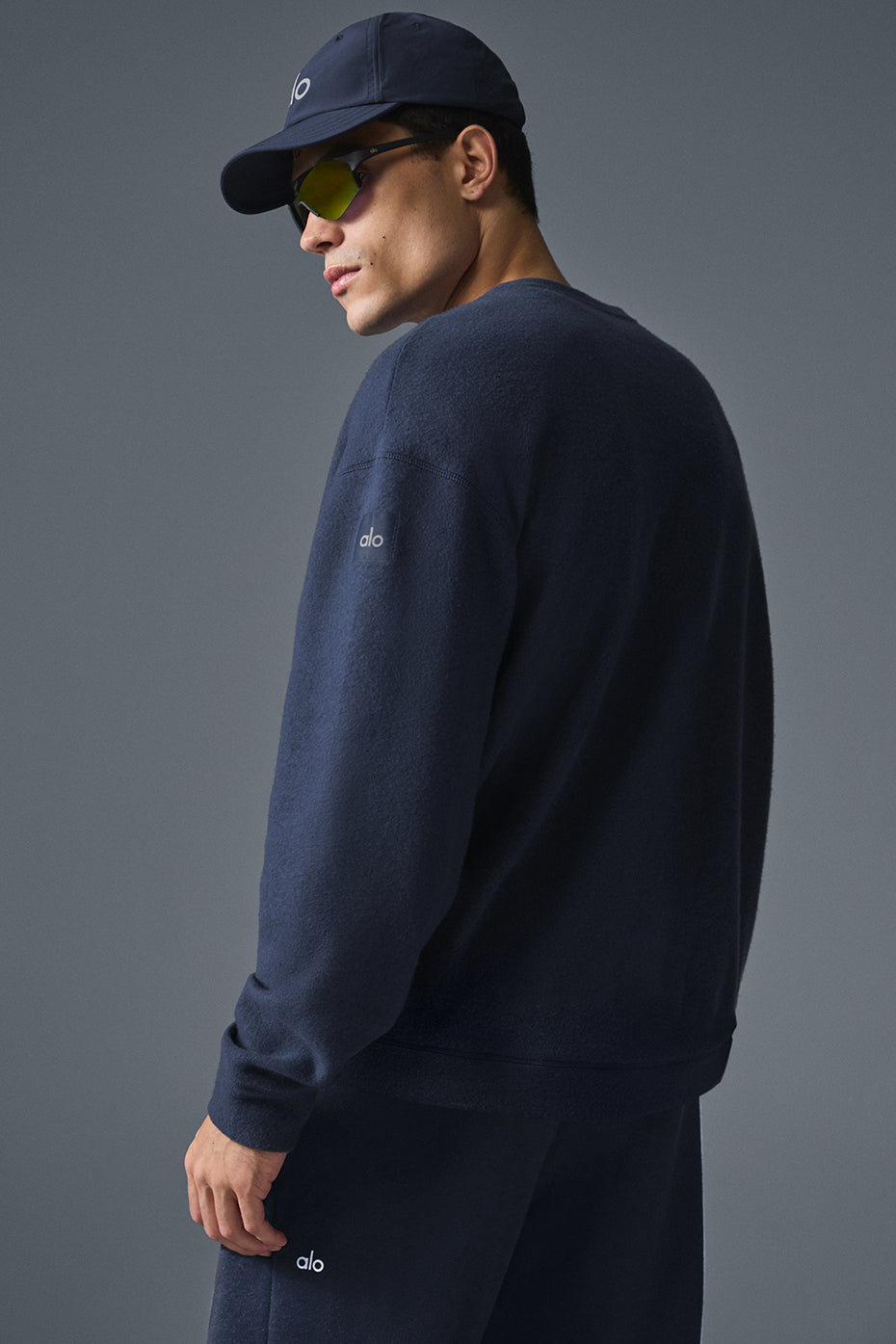 Side angle showing the relaxed fit of the navy crew neck sweatshirt.