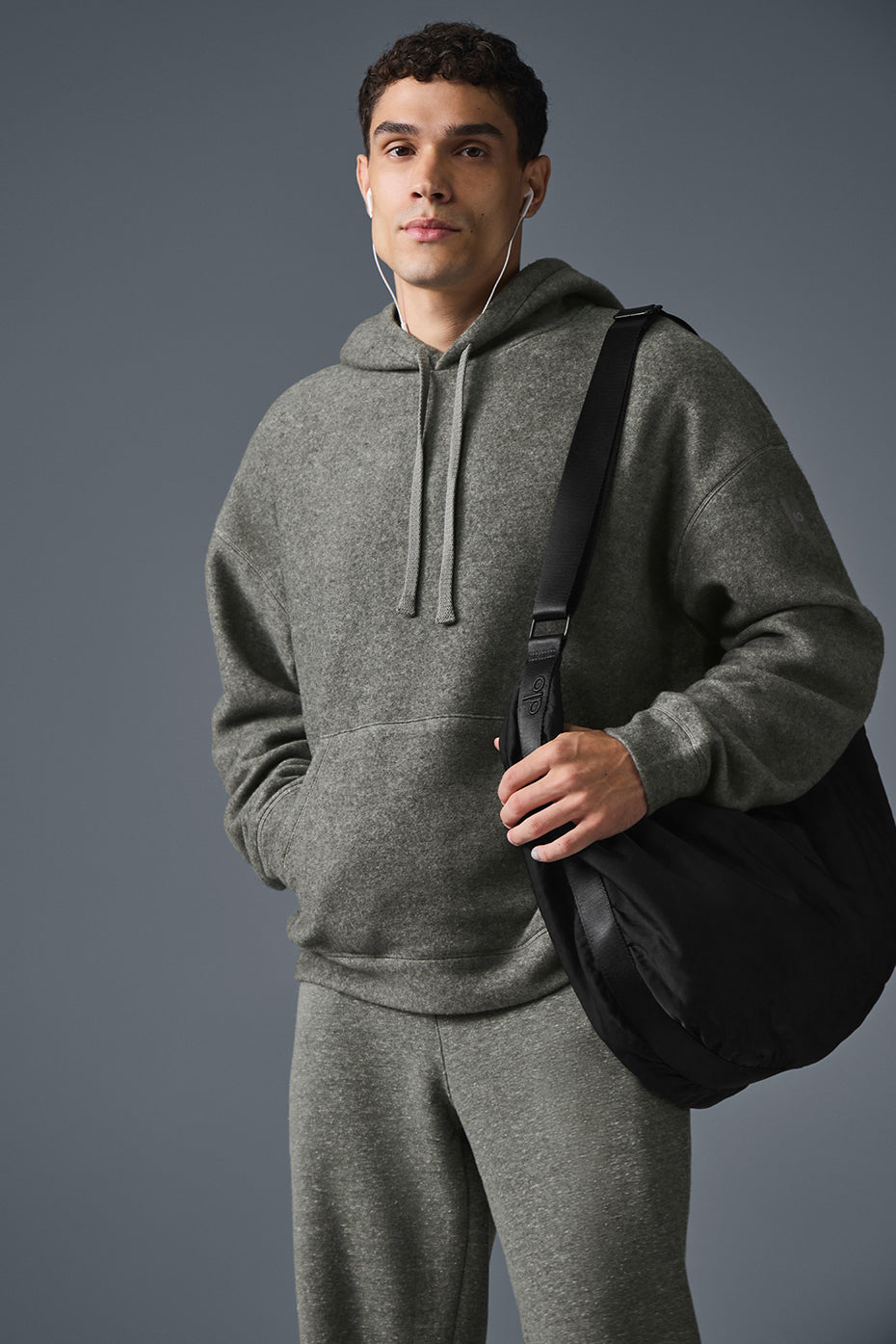 Front view of oversized hoodie on male model in outdoor setting