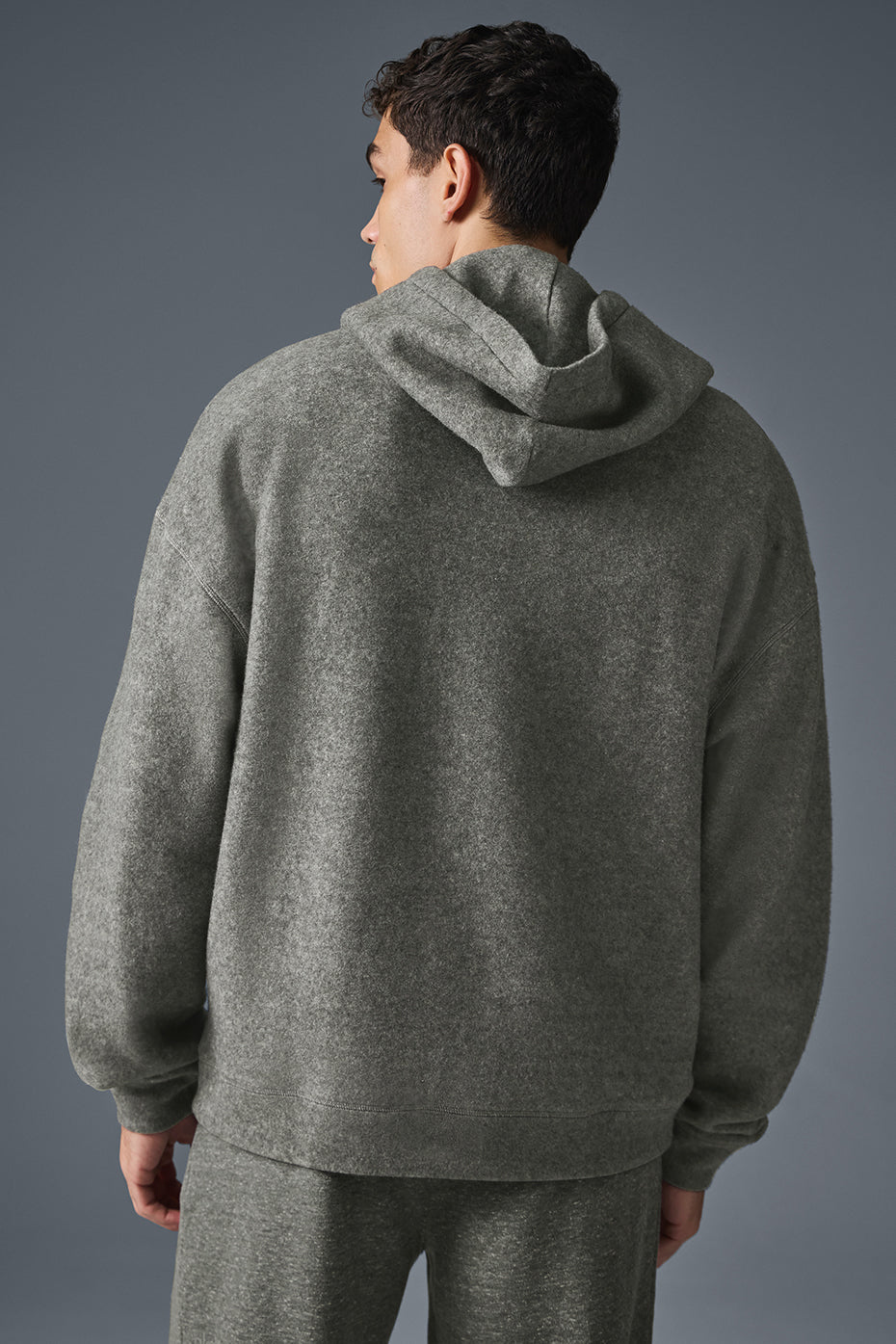 Close-up of drawcord hood and pouch detail on grey comfort hoodie
