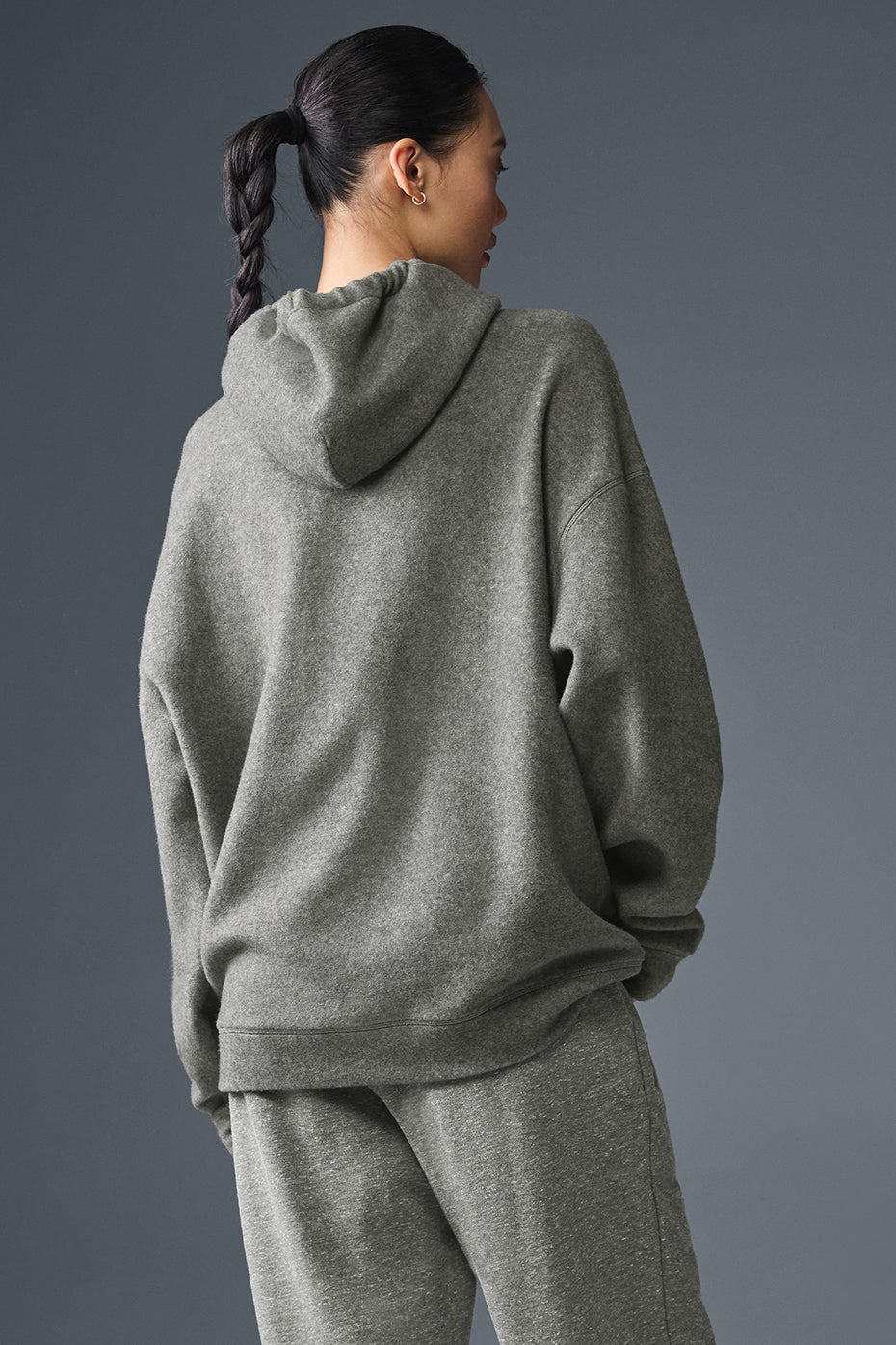 Womens oversized hoodie with layered streetwear fit, photographed downtown