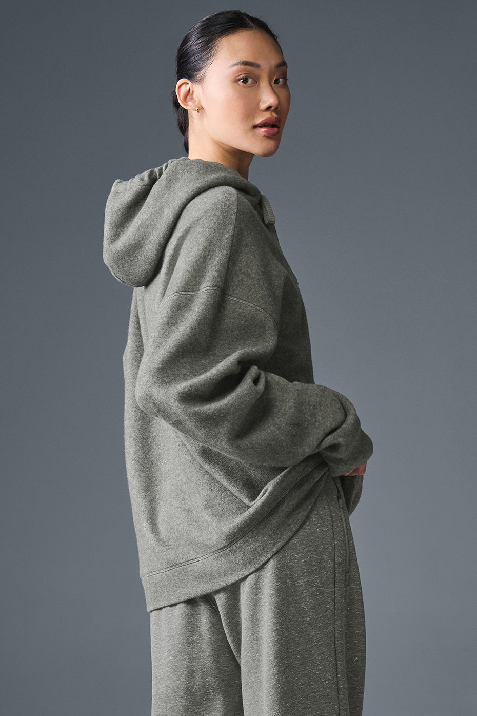 Oversized zip up hoodie folded on bench, highlighting soft grey fleece