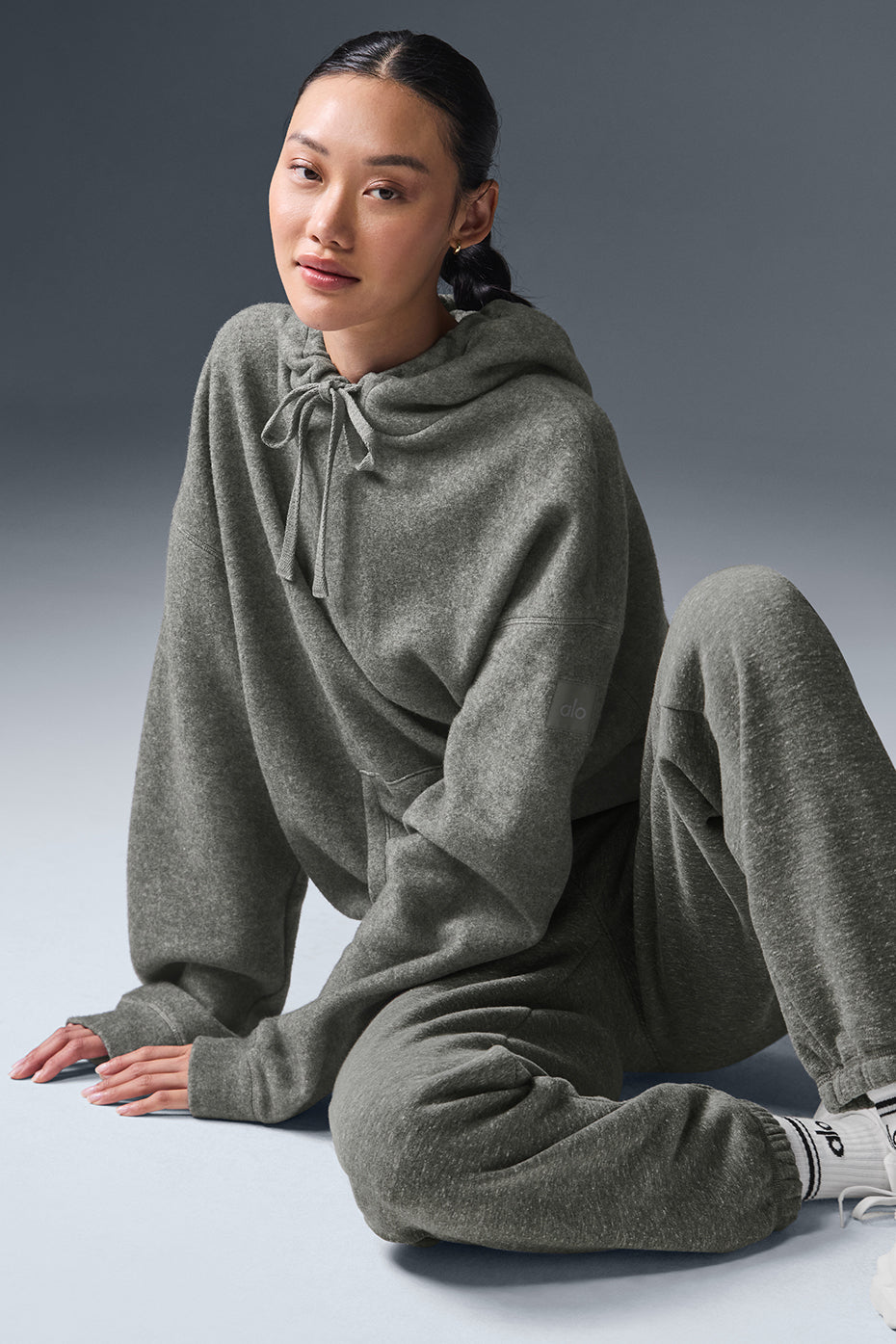 Womens oversized hoodie with layered streetwear fit, photographed downtown