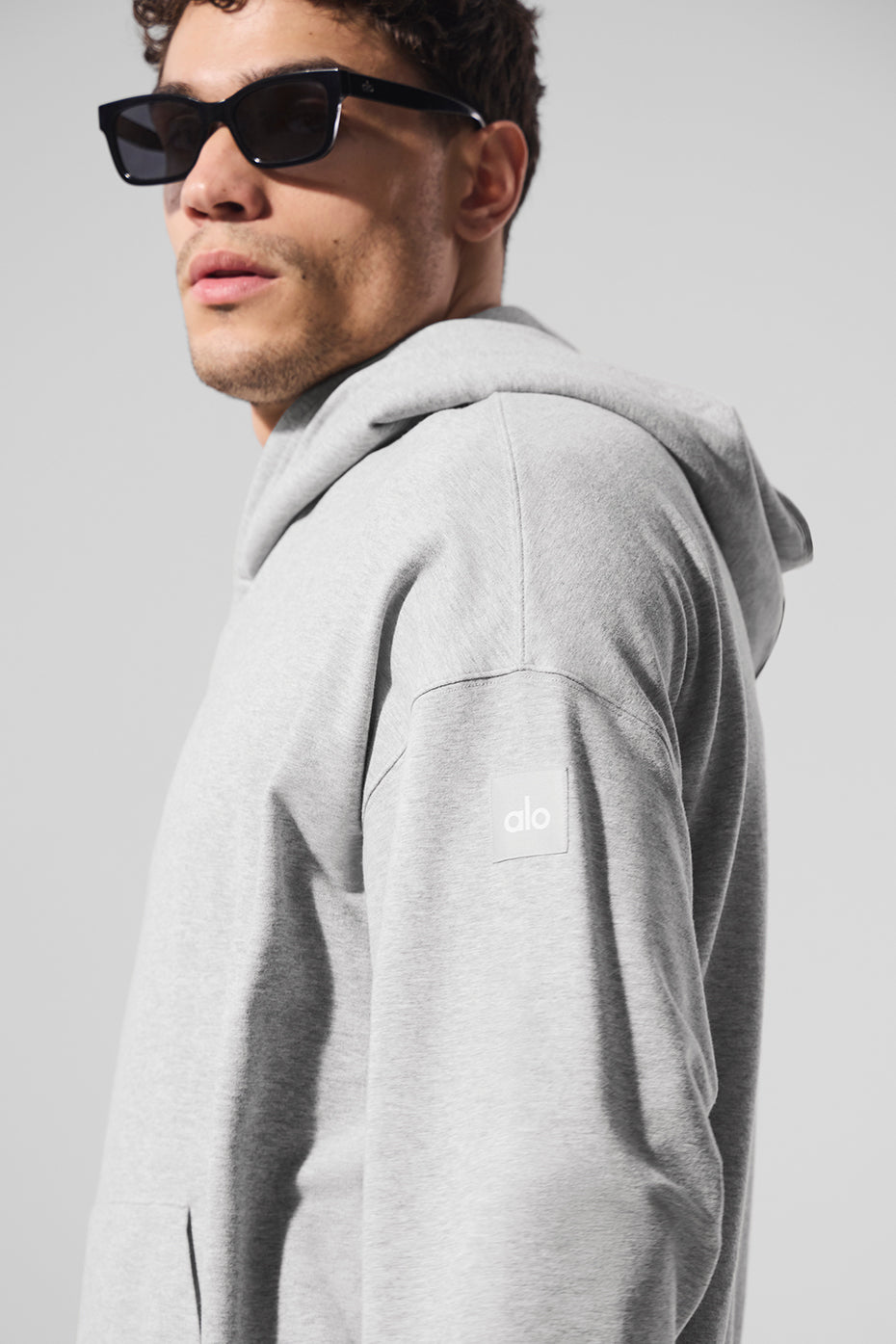 Man wearing grey comfort hoodie with jeans for casual outing