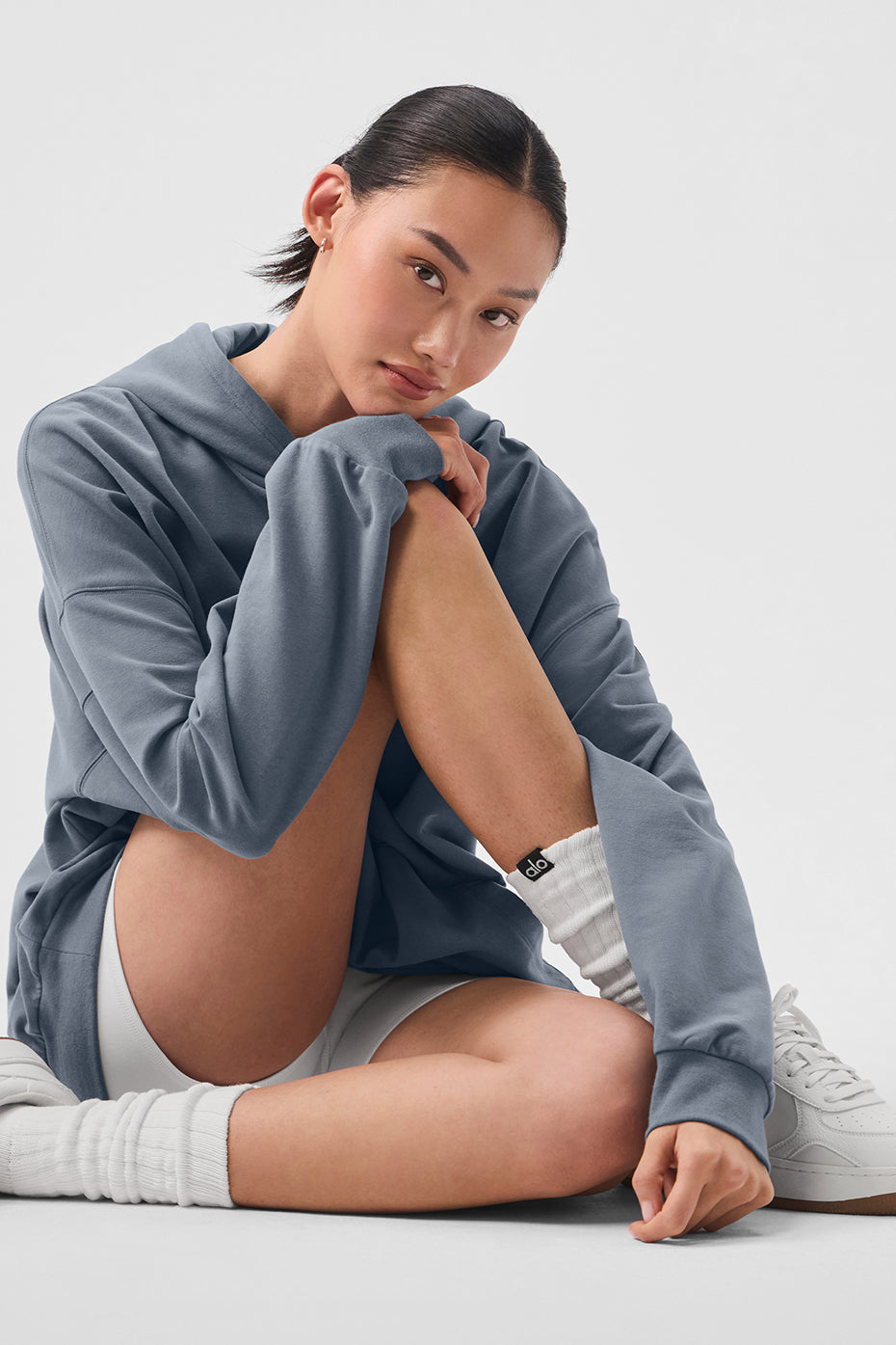 Side view of the hoodie, highlighting the dropped shoulders and kangaroo pocket.