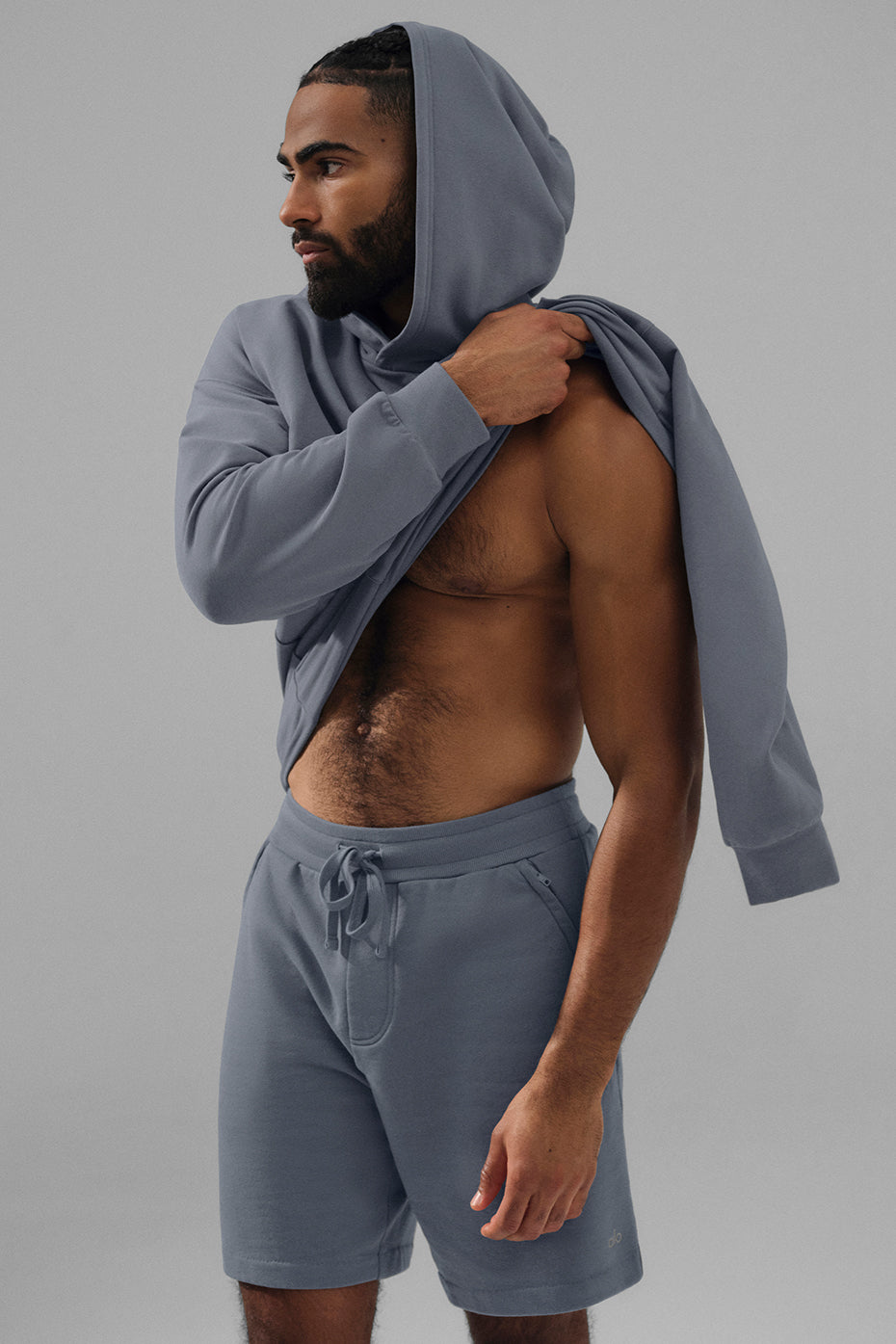 Detail shot of the kangaroo pocket on the grey hoodie, emphasizing comfort and practicality