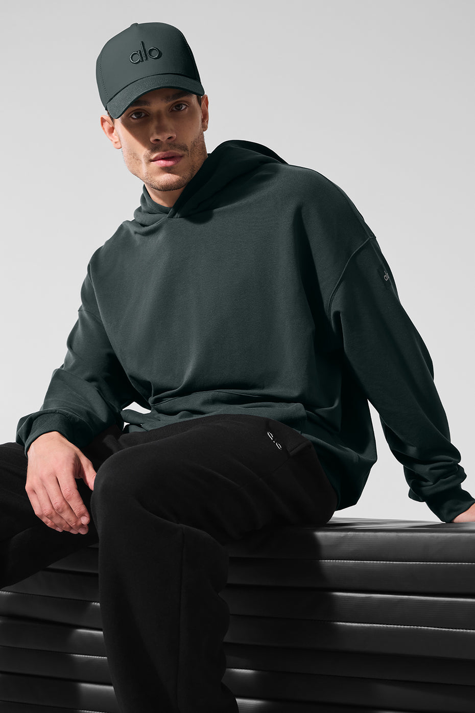 Front view of the mens charcoal hoodie highlighting the kangaroo pocket and dropped shoulders
