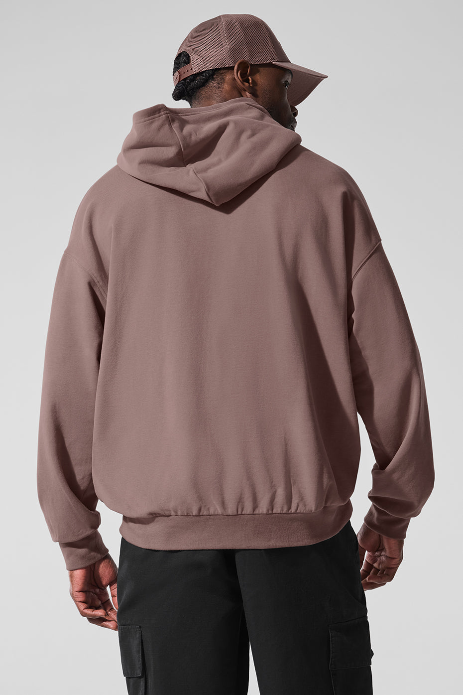 Model wearing the comfort hoodie styled with trousers for a business casual look